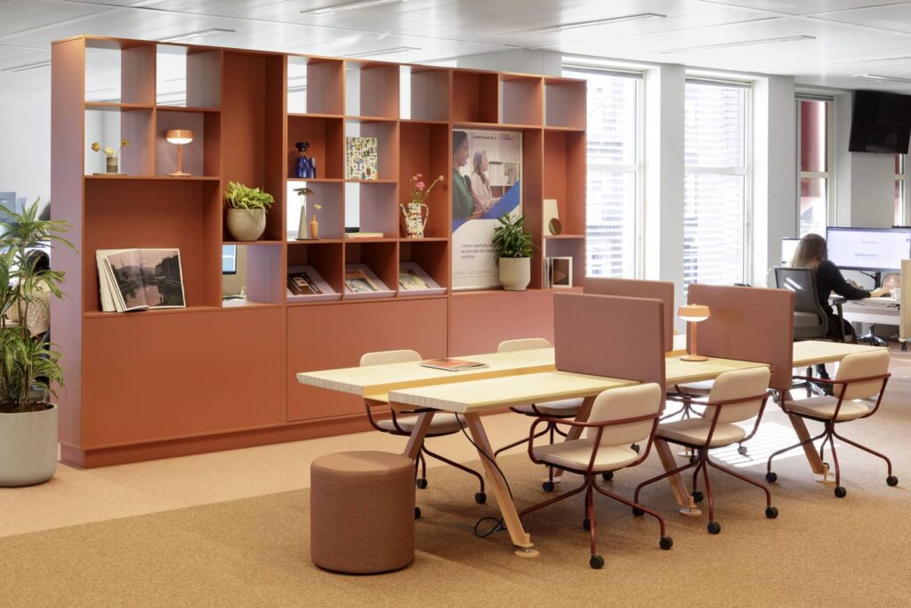 Cygnific Amsterdam: terracotta kastenwand met werkplekken en tafellampen
